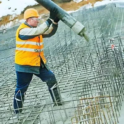Our concrete contractor, wearing safety glasses and a helmet operating a concrete pump in Dunedin.