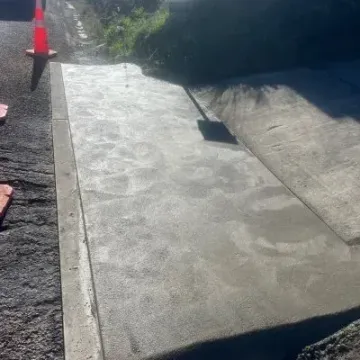 After: Broom-finish concrete driveway extension with crisp edging, Waikouaiti