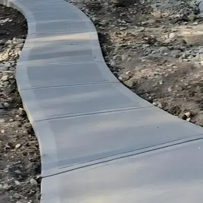 Sleek broom finished concrete path in Green Island.