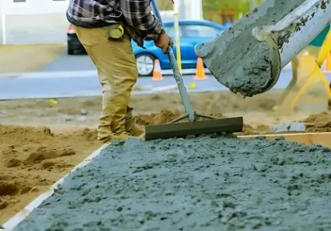Dunners Concrete placers pouring and leveling a new driveway near Portsmouth Drive, Dunedin.