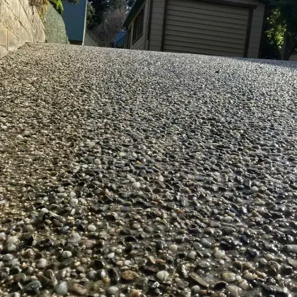 New exposed aggregate concrete driveway, close up shot revealing natural stones in Macandrew Bay, Dunedin.