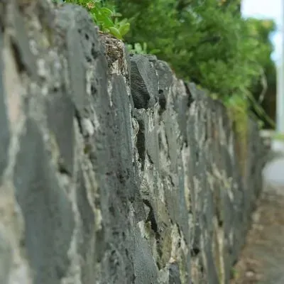 Natural stone retaining wall constructed outside commercial property on North East Valley Road, Dunedin.