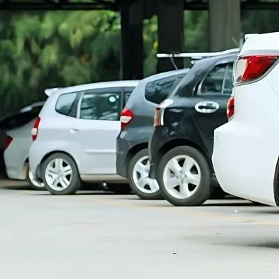 Concrete car park at residential complex in North East Valley with marked parking spaces.