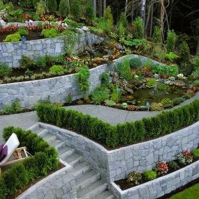 Beautiful landscape with retaining walls, decorative concrete paths, and surfaces.
