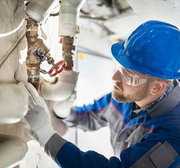 Worker Repairs the Pipe — Enid, OK — Northwest Plumbing & Mechanical Inc