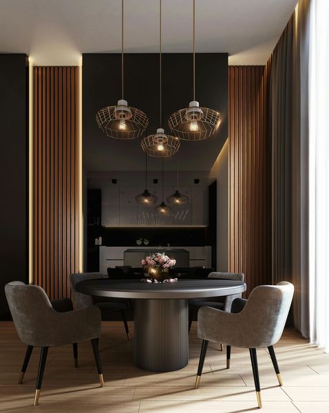 Dining room: Round table, gray chairs, three pendant lights, and dark accent wall.