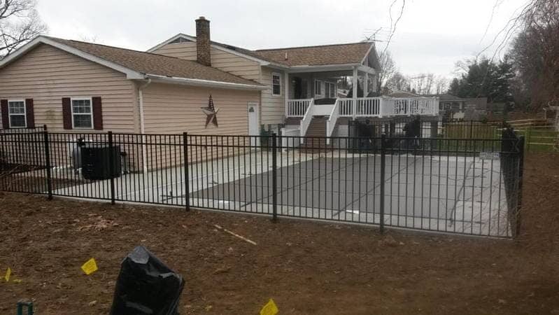 Iron Black Fence In Front Of House — Fence Repair in Williamsport, MD