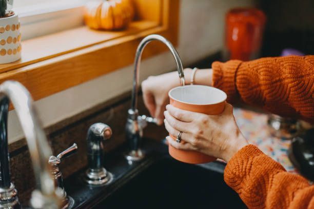 Woman Refilling A Cup Of Water — McAllen, TX — Clear Choice H2O
