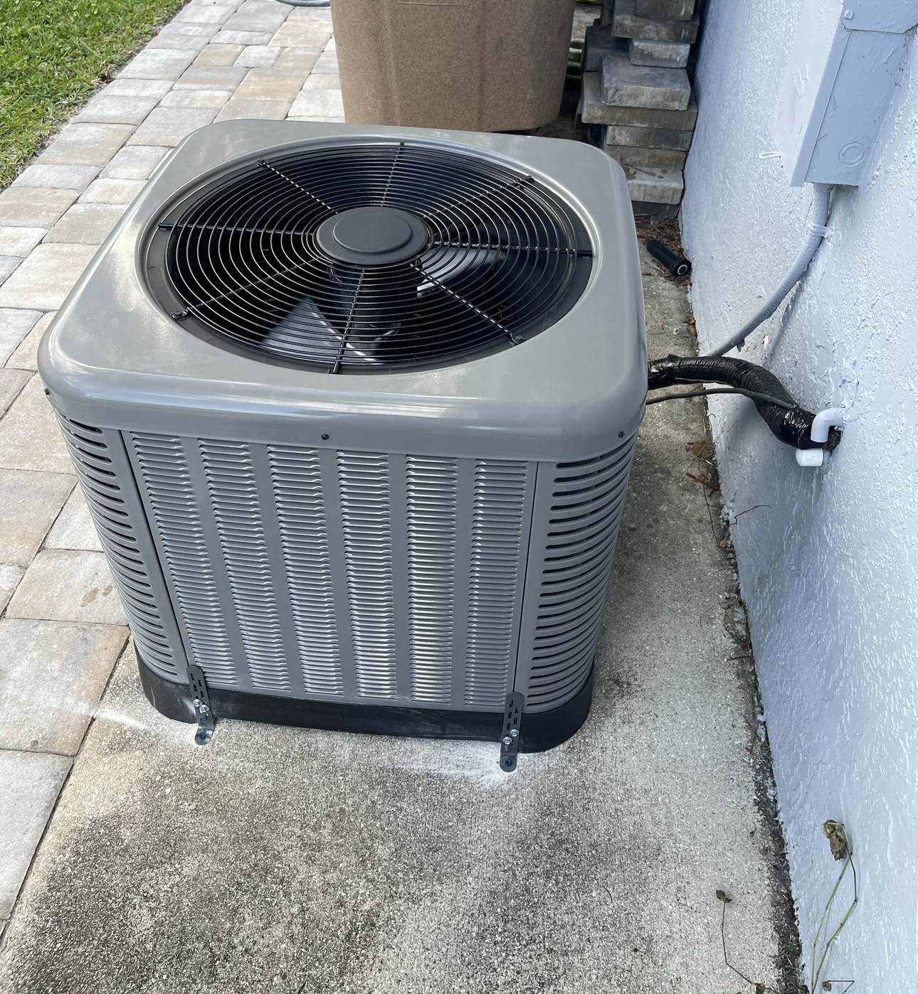 An air conditioner is sitting on the side of a building.