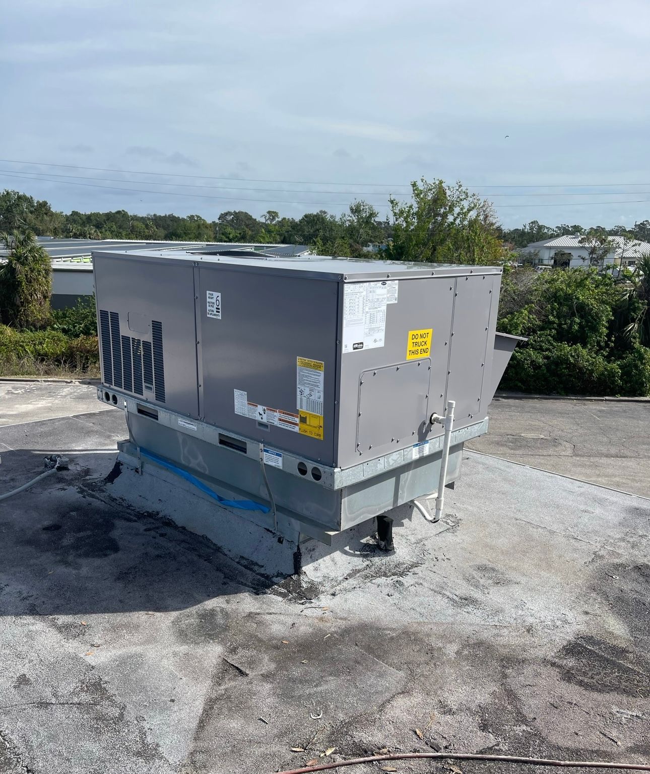 A large gray box is sitting on top of a concrete roof.