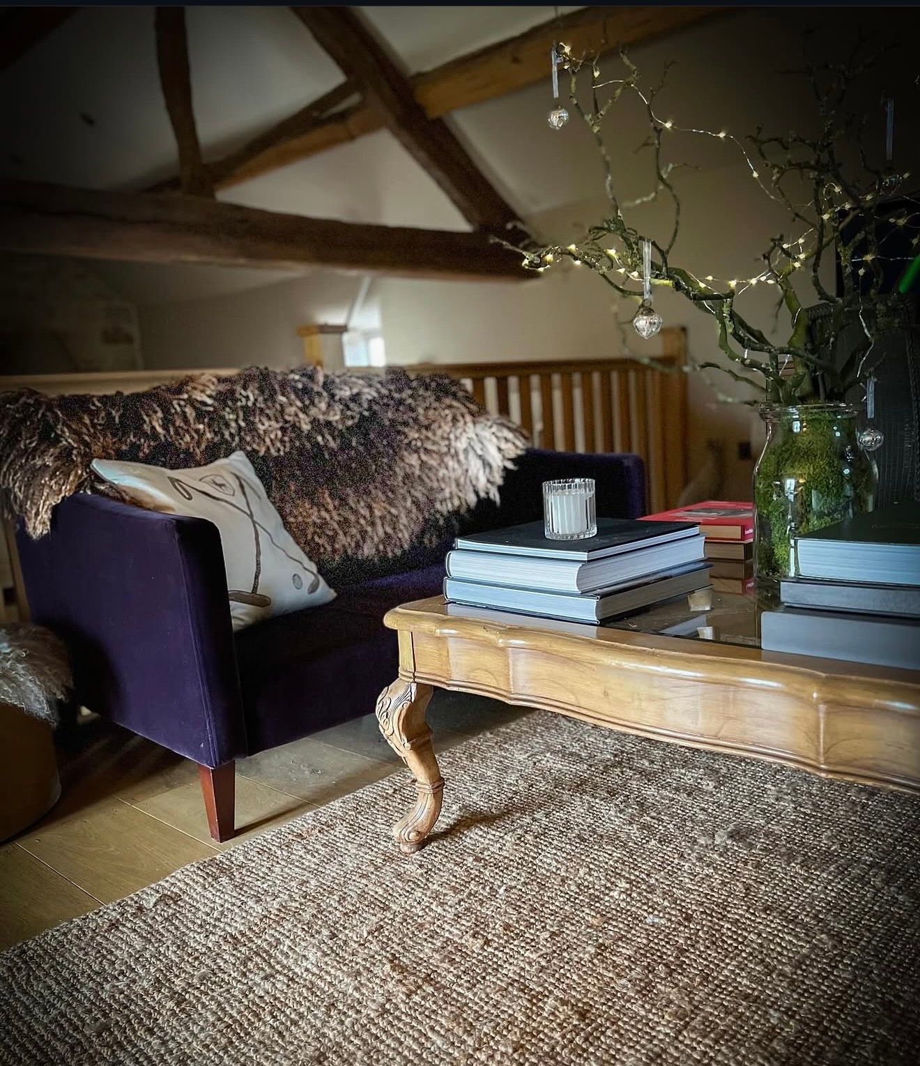 Large felted fleece rug by Karolina Begier styled over a sofa in an interior setting, highlighting its scale and texture.