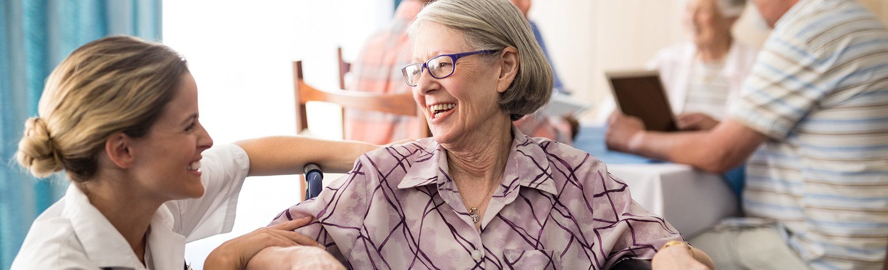 Image of a resident laughing with a caregiver