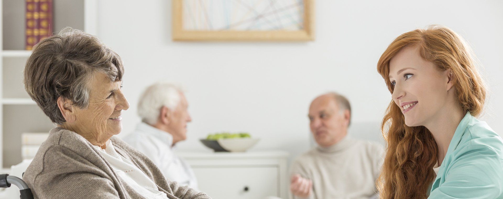 Image of  a caregiver and resident enjoying a conversation
