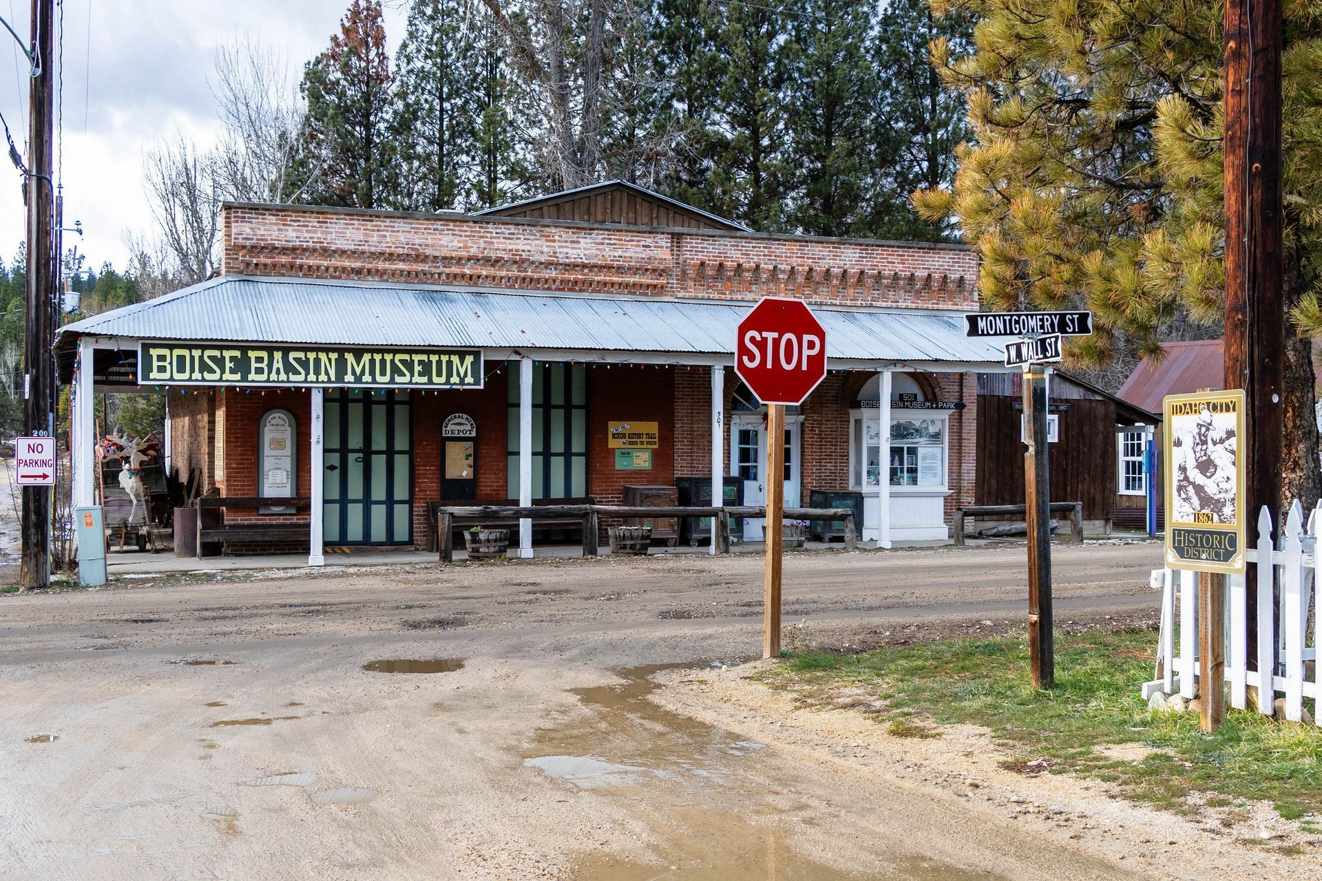 Boise Basin Museum, a historic wooden building with a stop sign and street signs.
