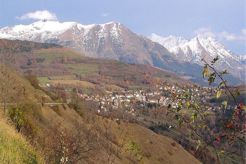 Une chaîne de montagnes enneigée avec une petite ville au premier plan