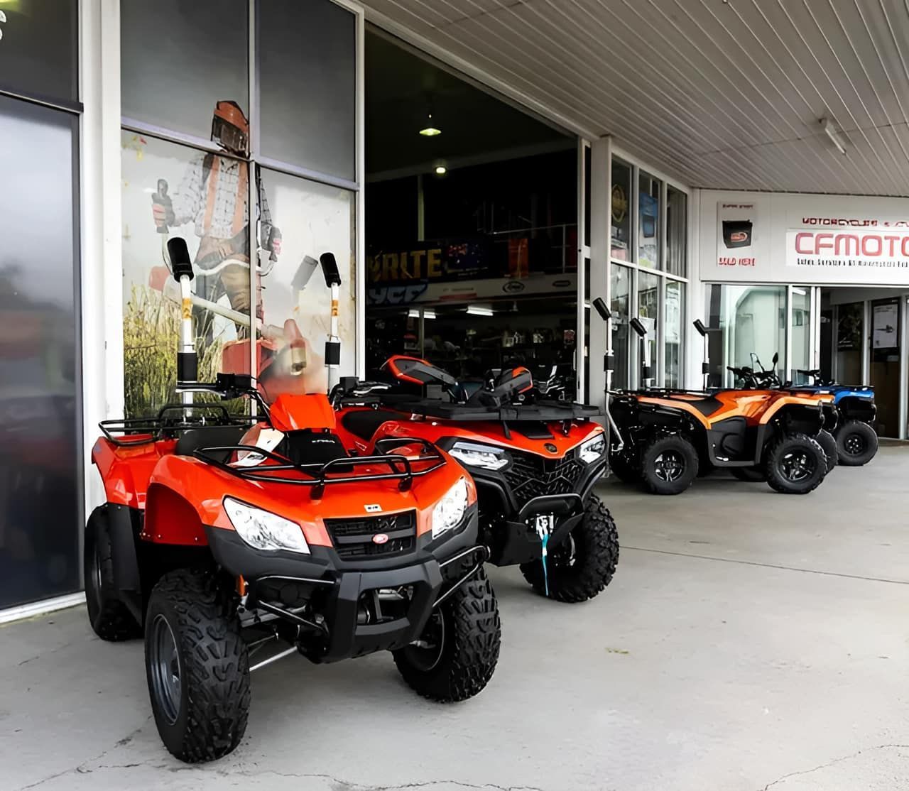 A Row Of ATVs Parked In Front Of A Building That Says Cfmoto — Coastal Farm & Motorcycles In Innisfail, QLD