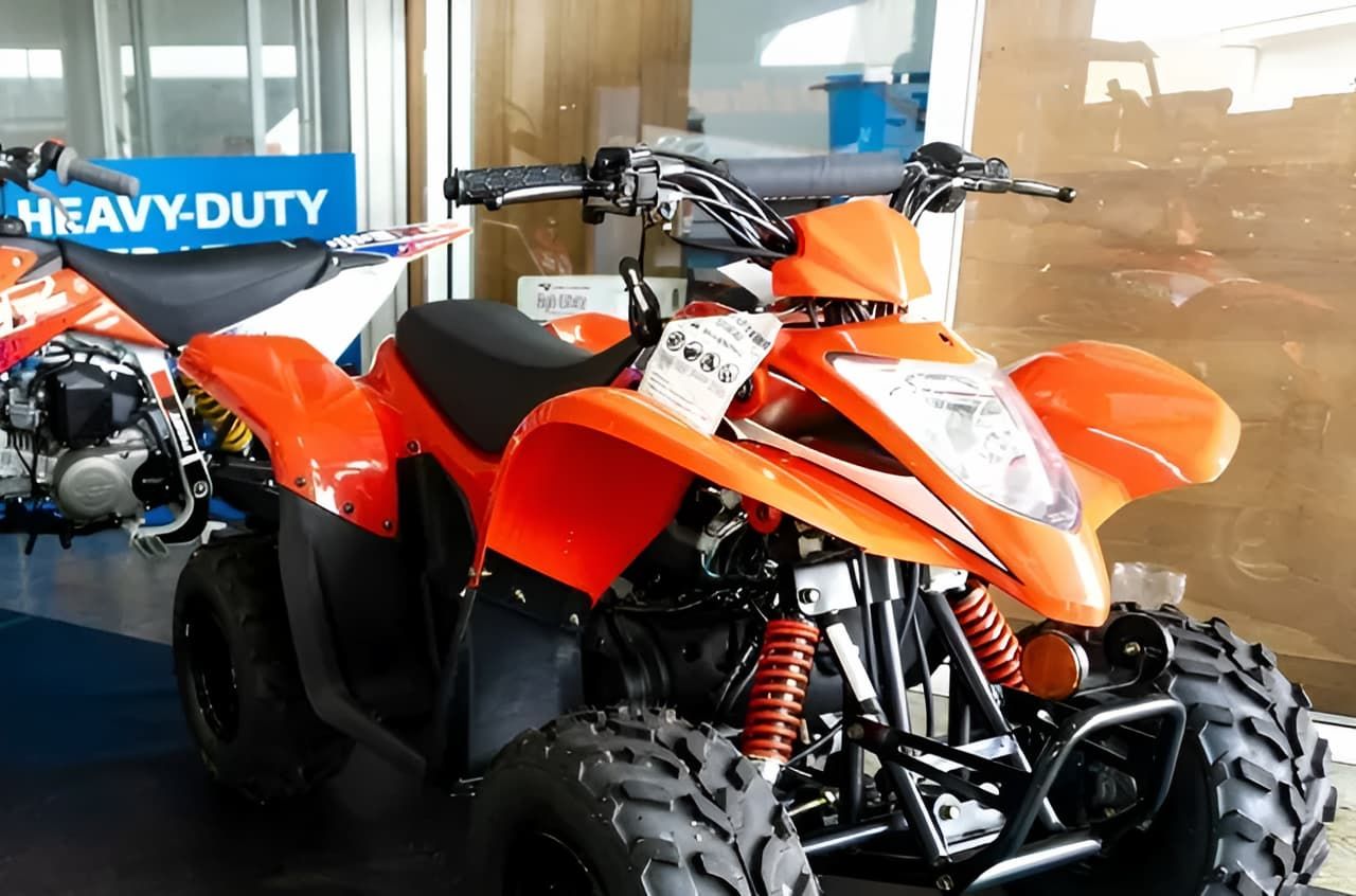 Two ATVs Are Parked Next To Each Other In A Garage — Coastal Farm & Motorcycles In Cairns, QLD