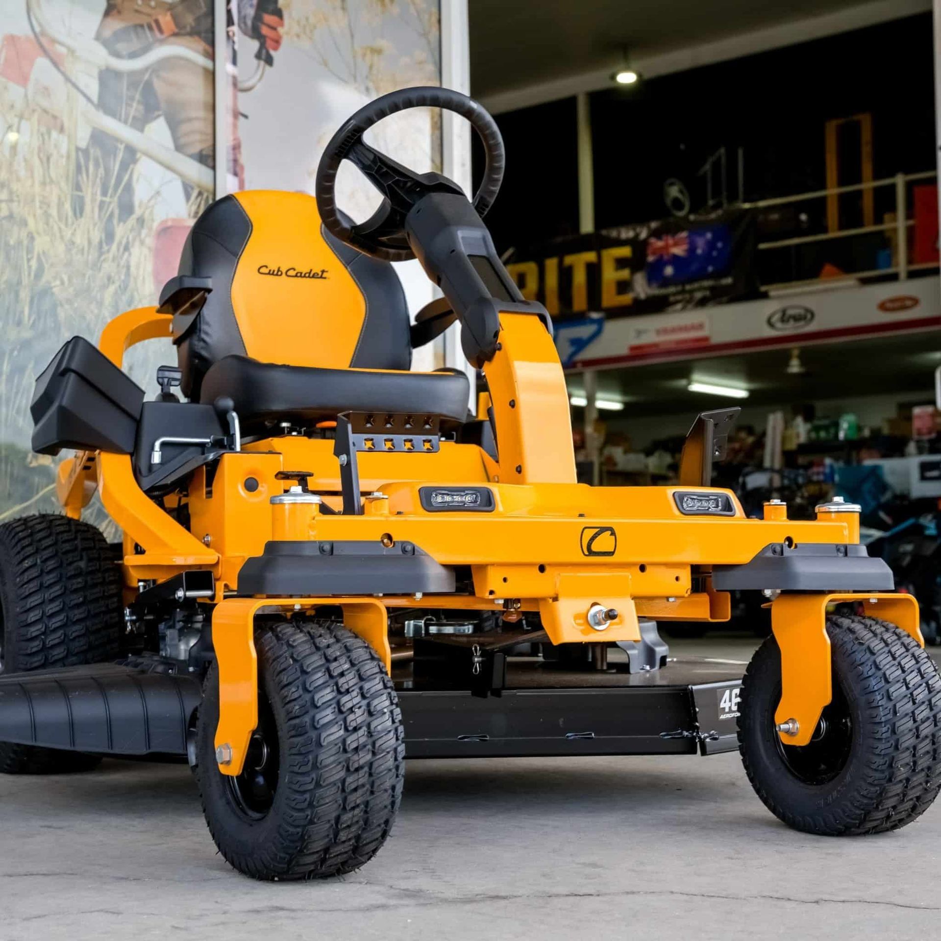 A Yellow Lawn Mower Is Parked In Front Of A Store — Coastal Farm & Motorcycles In Tully, QLD
