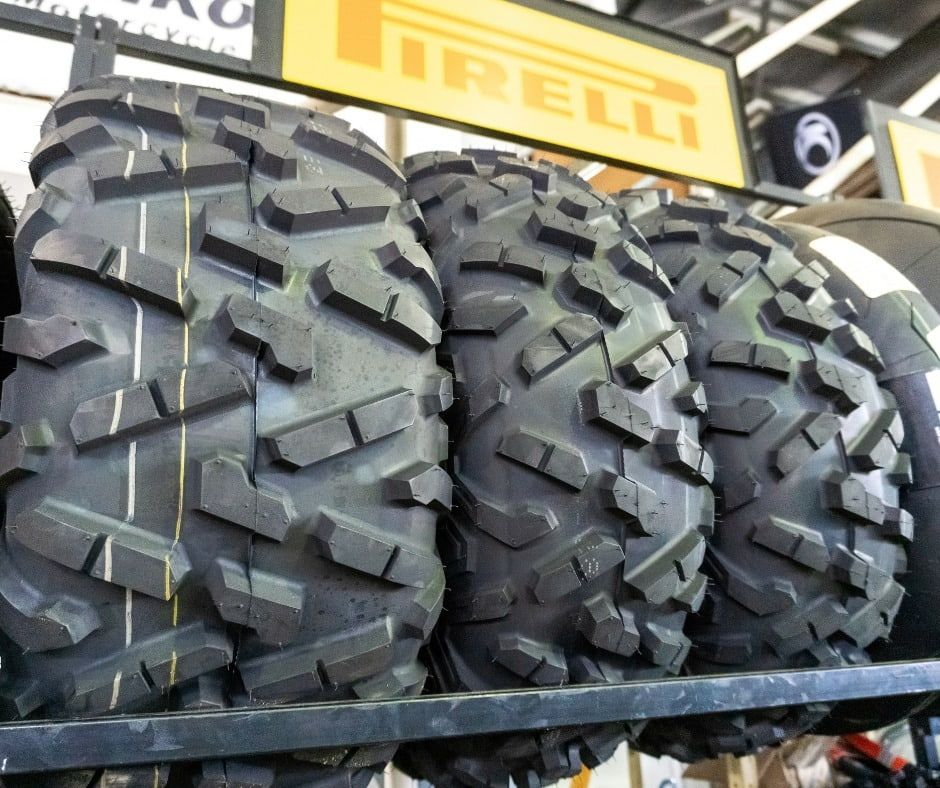 Three Tires Are Stacked On Top Of Each Other Under A Sign That Says Irelli — Coastal Farm & Motorcycles In Innisfail, QLD