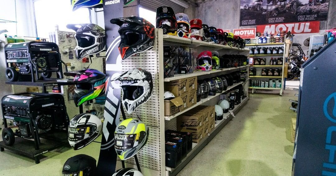 A Store Filled With Lots Of Helmets And Motorcycle Parts — Coastal Farm & Motorcycles In Innisfail, QLD