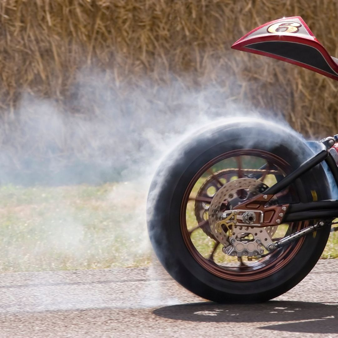A Close Up Of A Motorcycle Wheel With Smoke Coming Out Of It — Coastal Farm & Motorcycles In Cairns, QLD