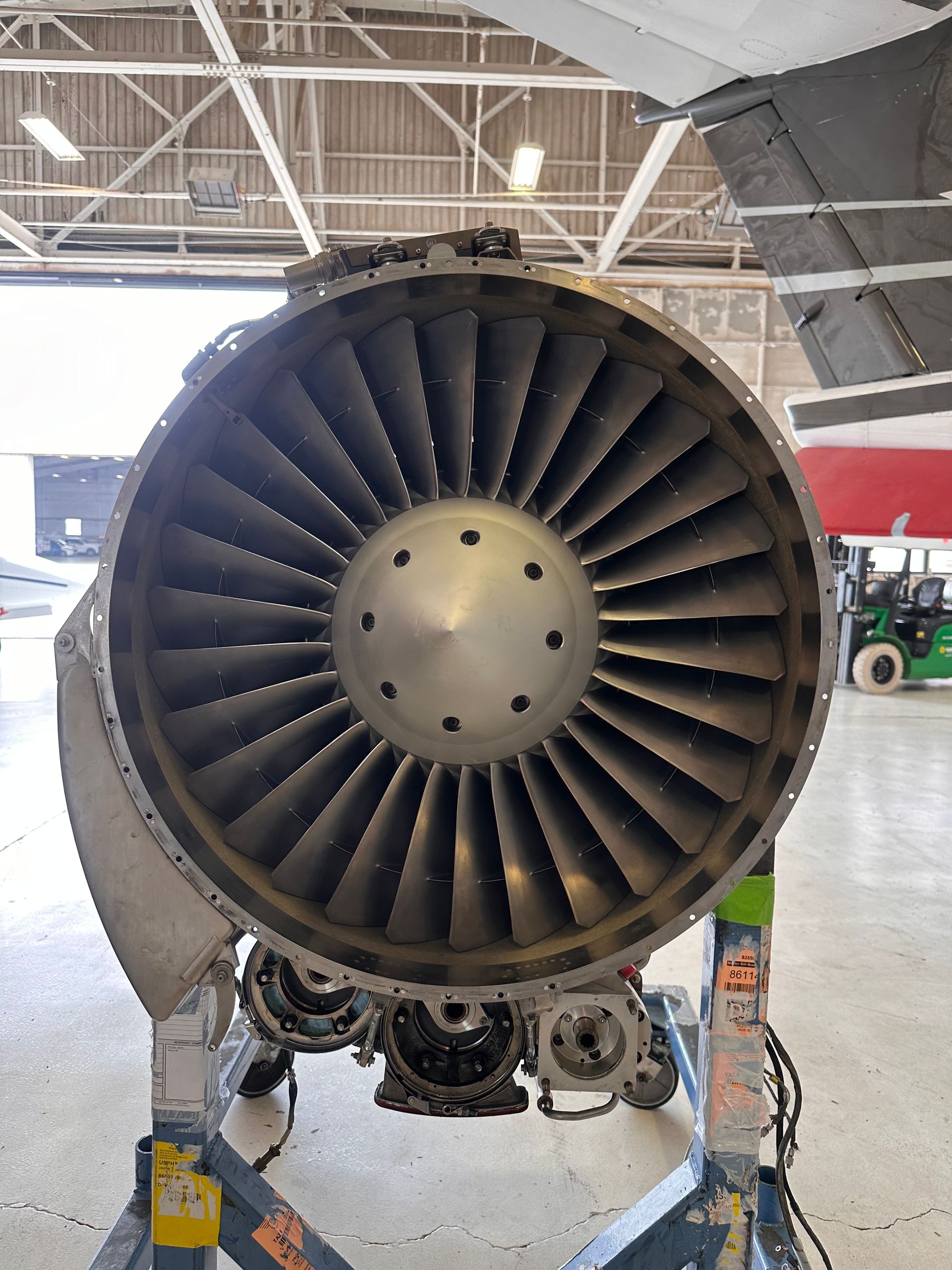 A close up of an airplane engine on a runway.
