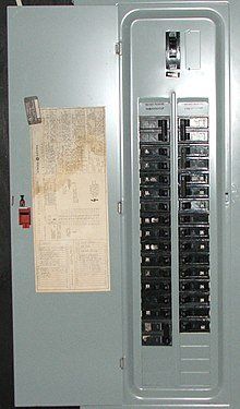 A close up of a electrical panel with a paper on it.