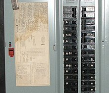 A close up of a electrical panel with a paper on it.