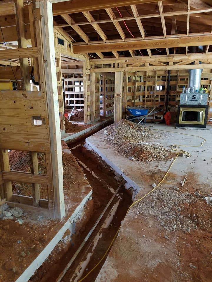 A building under construction with a lot of dirt on the floor.
