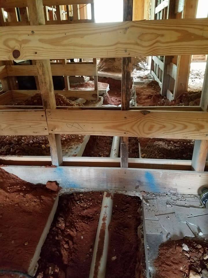 A wooden structure with a lot of dirt underneath it.