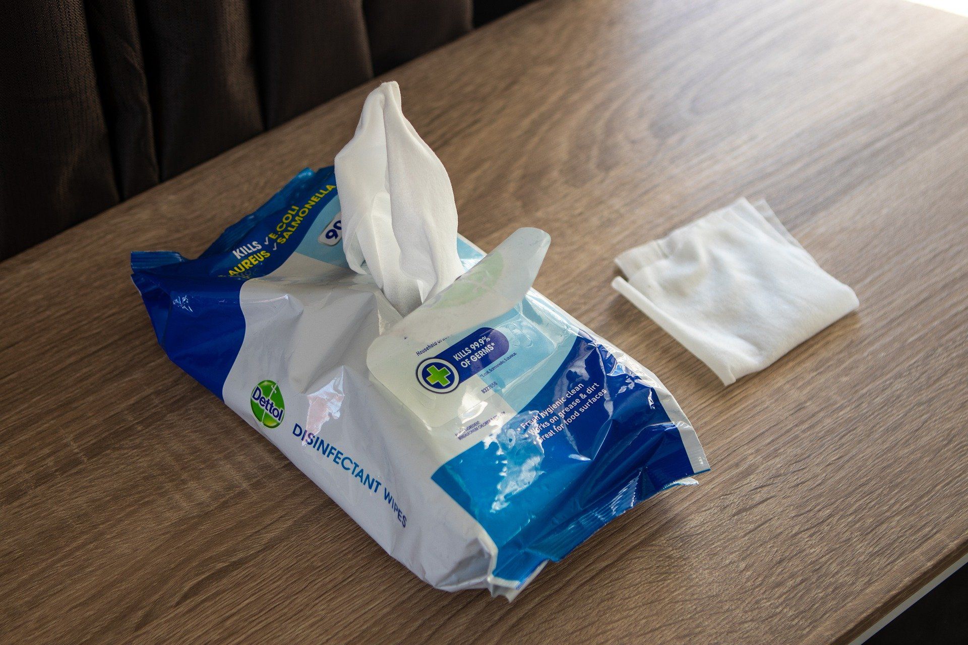 A bag of wipes is sitting on a wooden table.
