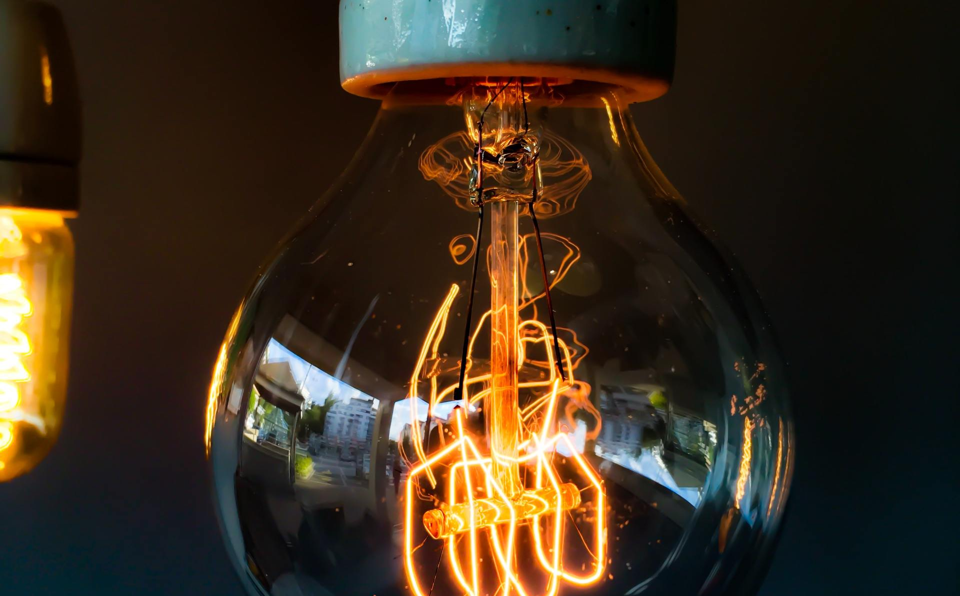 A close up of a light bulb glowing in the dark.