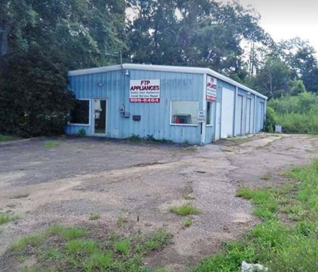 A blue building with a sign that says appliances on it