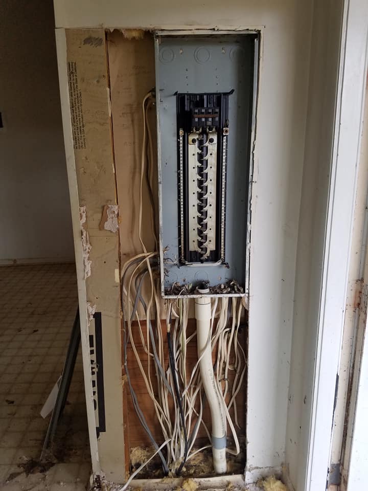 A electrical box with a lot of wires coming out of it.