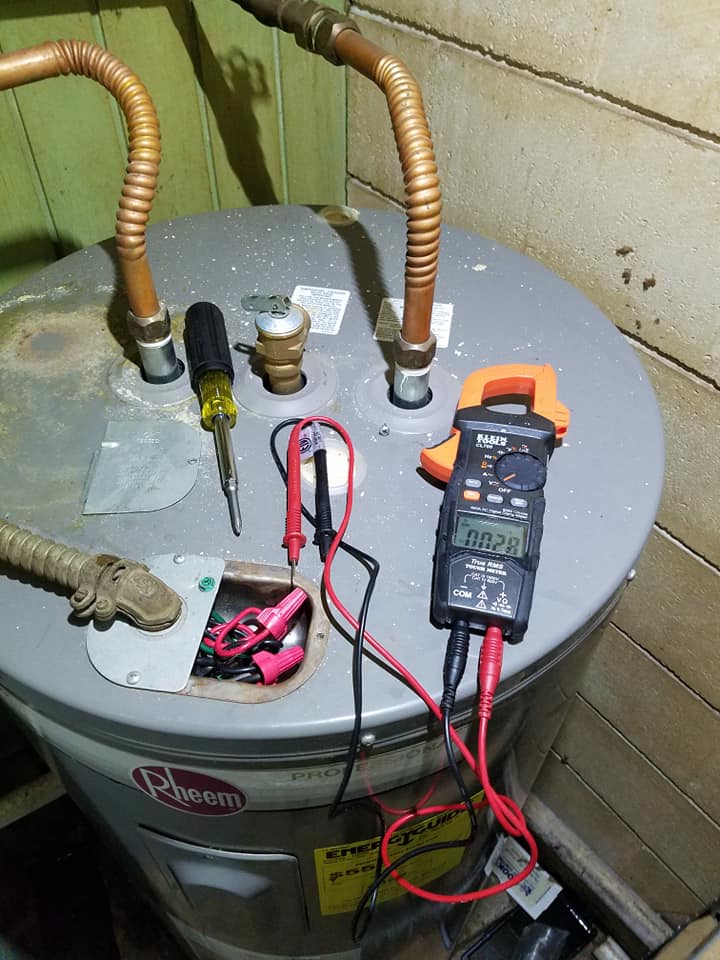 A water heater with a clamp on top of it.