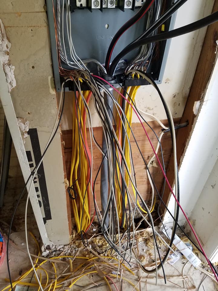 A bunch of wires are coming out of a electrical box.