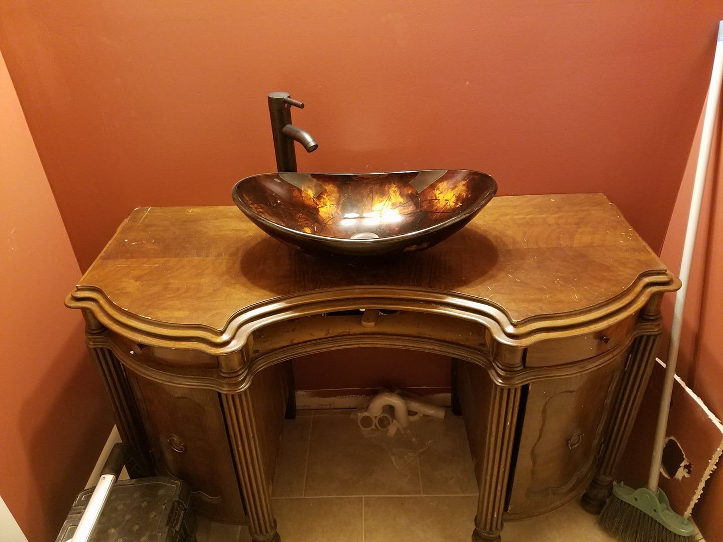 A bathroom vanity with a sink and a faucet