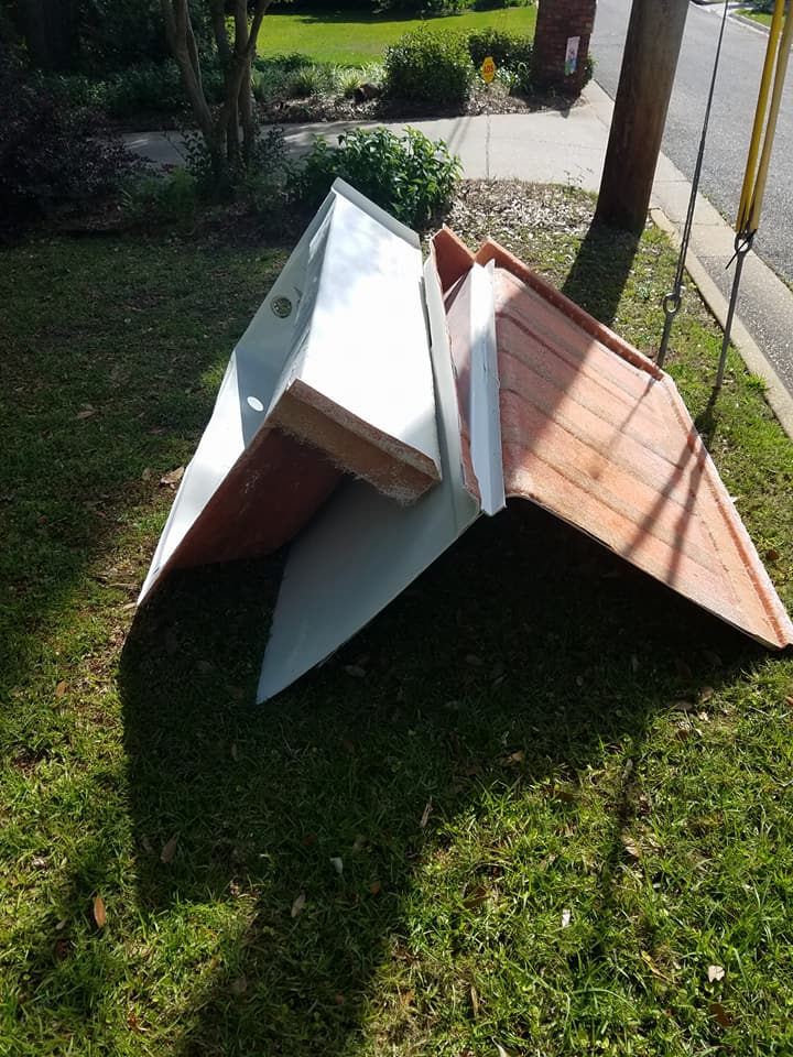 A wooden dog house is sitting on top of a lush green lawn.