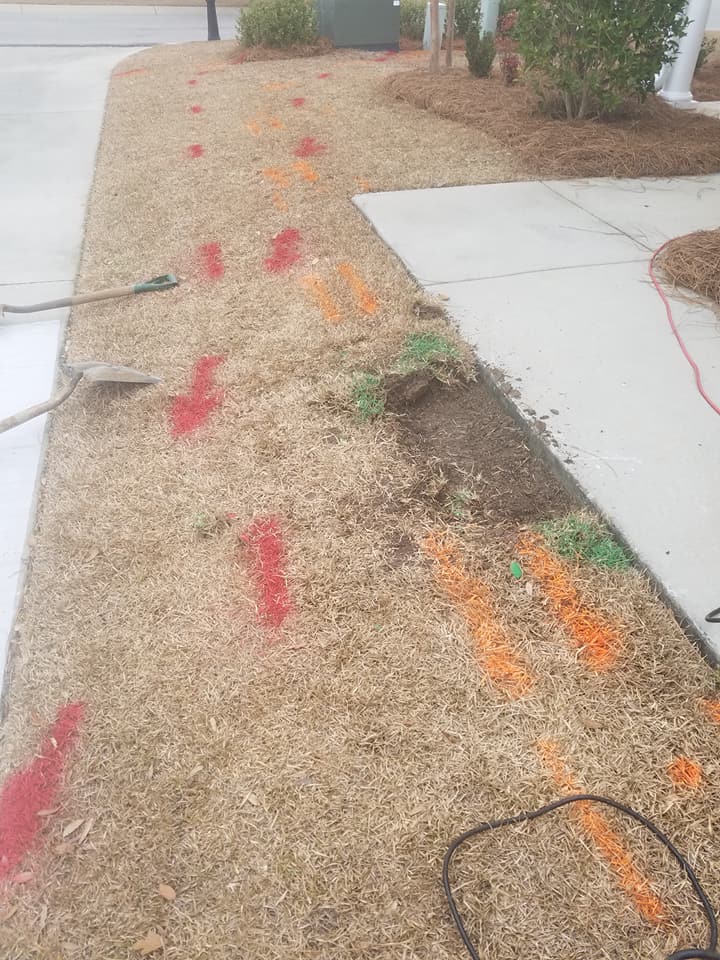 A sidewalk with red and orange arrows painted on it.