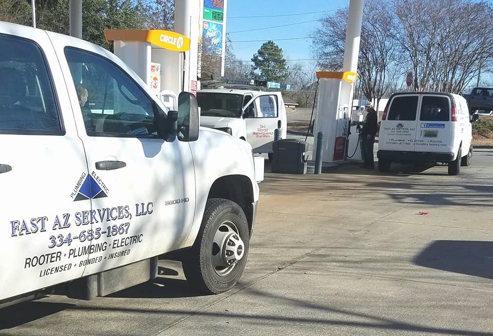 A fast az services truck is parked at a gas station