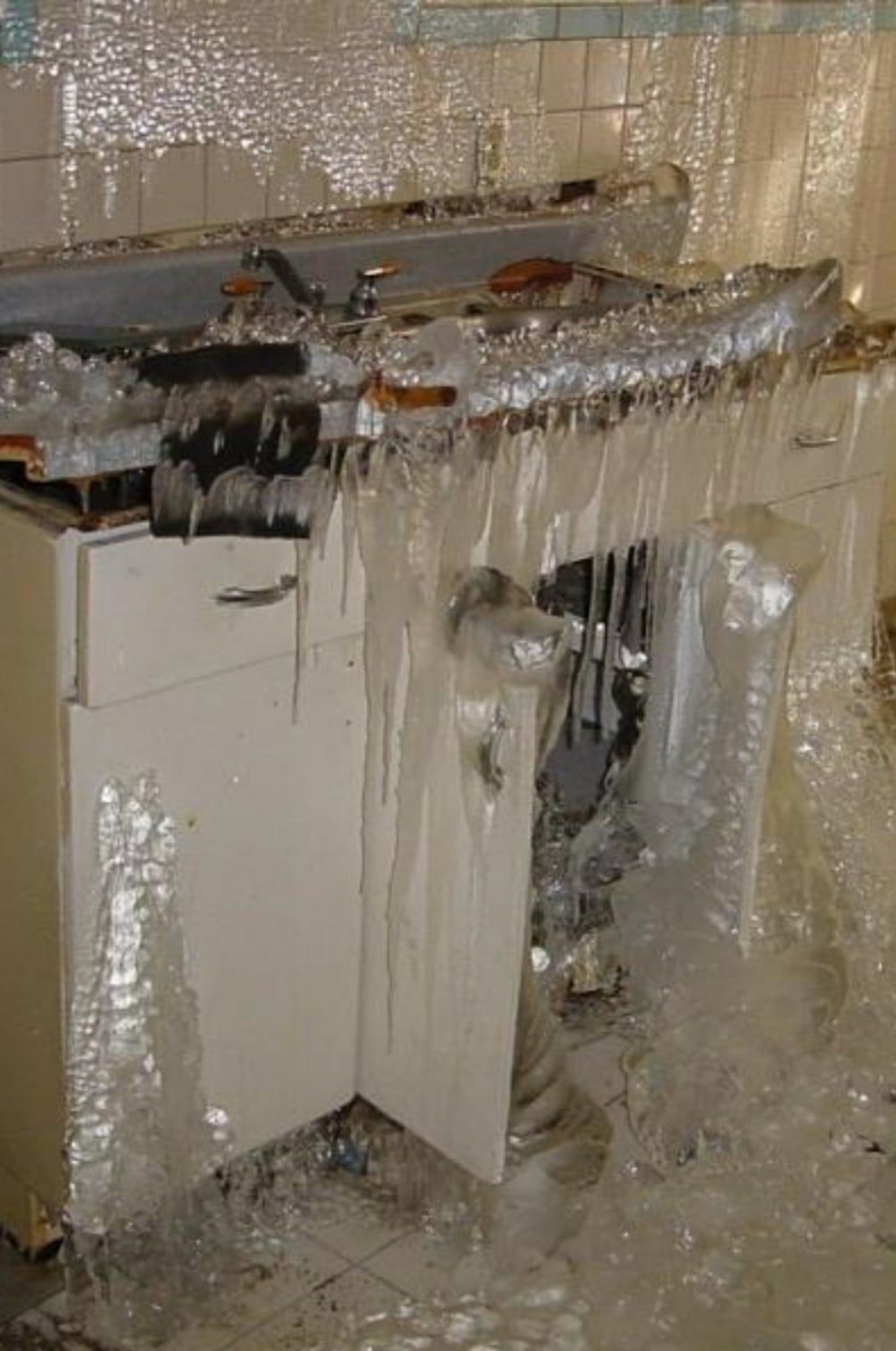 A kitchen with a sink and cabinets covered in bubble wrap.