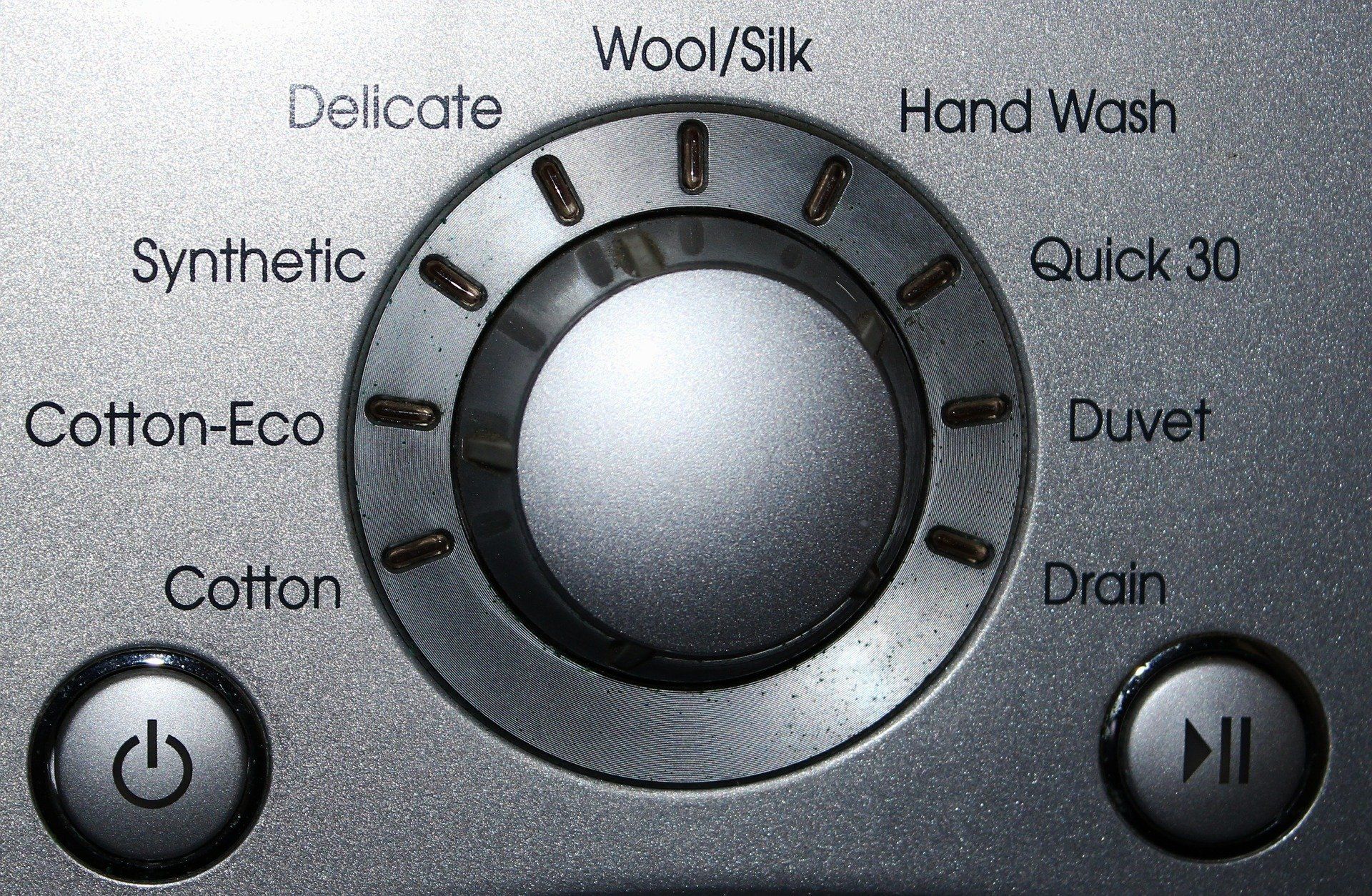 A close up of a washing machine 's control panel