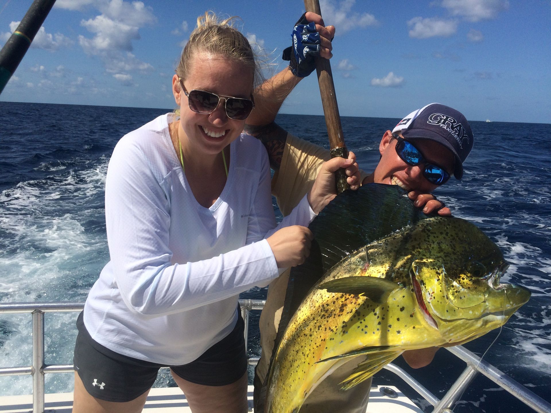 Woman Showing a Big Yellow Fish