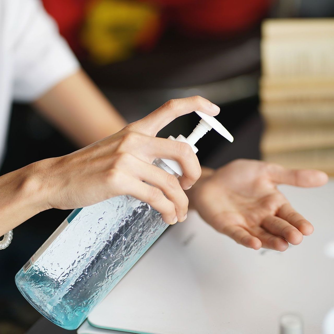 A person is applying hand sanitizer to their hands