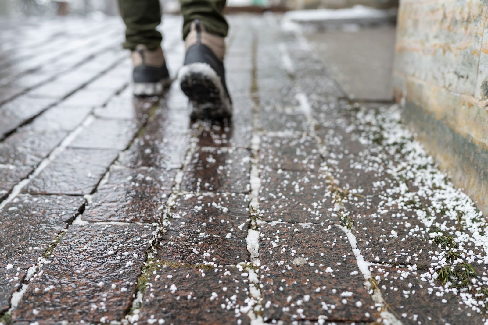 Salt Grains On Icy Sidewalk — Stewartville, MN — Complete Outdoor Service LLC