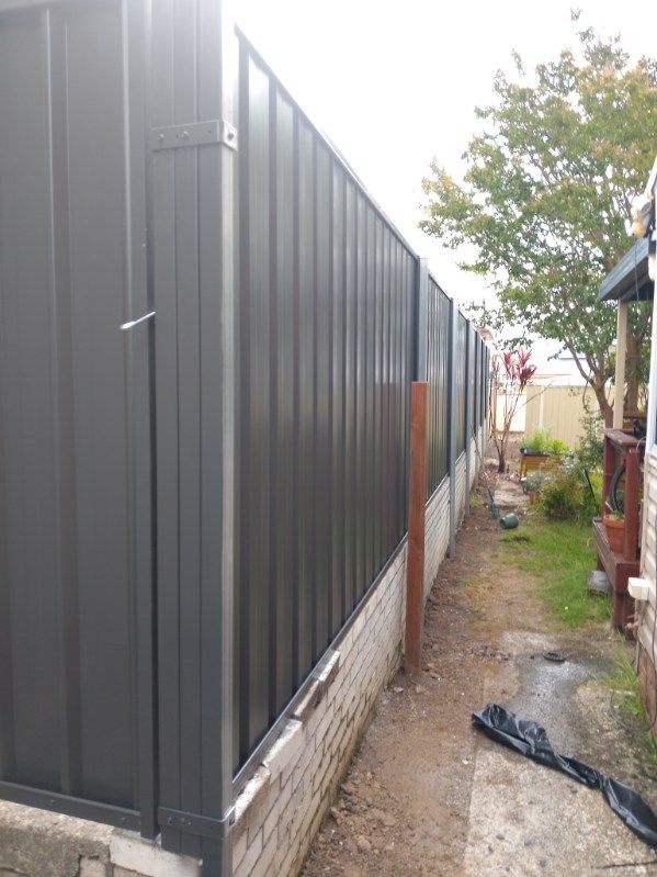 A Fence Is Being Built In The Backyard Of A House — A Betta Fence 'N' Yard In Wauchope, NSW