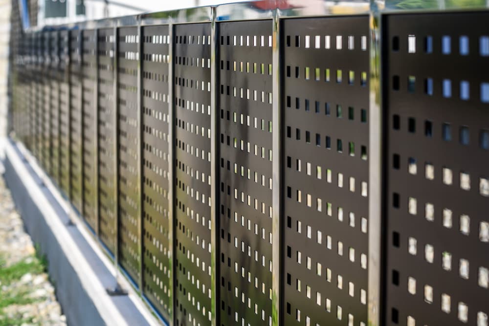 A Close Up Of A Metal Fence With Holes In It — A Betta Fence 'N' Yard In Port Macquarie, NSW