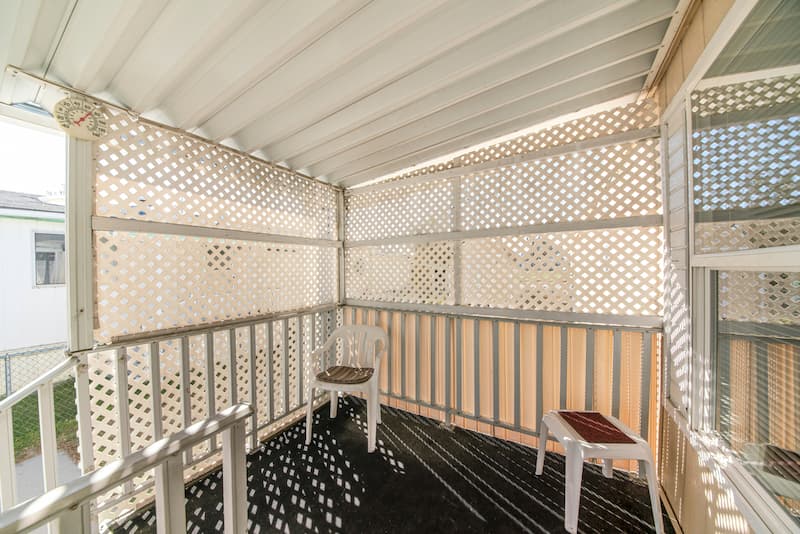 A Balcony With A Chair And A Table On It — A Betta Fence 'N' Yard In Port Macquarie, NSW