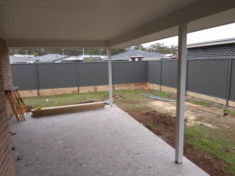 A Patio With A Fence In The Background And A Ladder In The Foreground — A Betta Fence 'N' Yard In Port Macquarie, NSW