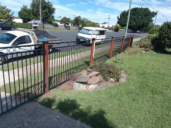 A White Van Is Parked Behind A Metal Fence — A Betta Fence 'N' Yard In Port Macquarie, NSW